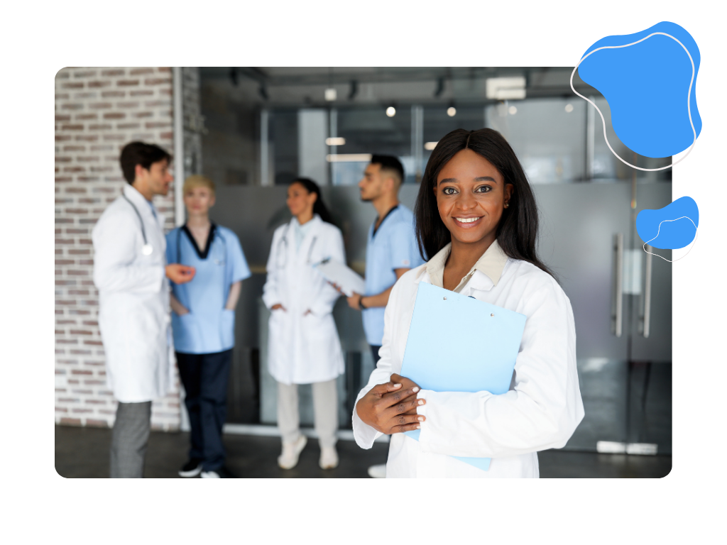 A doctor smiling happily as her group stands behind her.